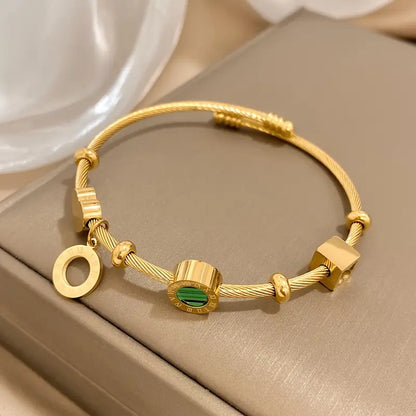 Gold rigid bracelet with geometric pendants - Celeste